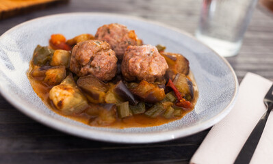 Cooked meatballs with stewed eggplant with haze in bowl