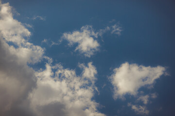 White heap clouds in the blue peaceful sky. The concept of psychological calmness and health. Peace of mind with the forces of nature. Air travel concept.