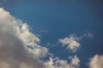 White heap clouds in the blue peaceful sky. The concept of psychological calmness and health. Peace of mind with the forces of nature. Air travel concept.