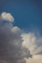 White heap clouds in the blue peaceful sky. The concept of psychological calmness and health. Peace of mind with the forces of nature. Air travel concept.