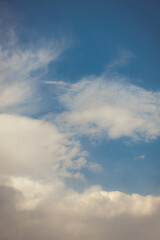White heap clouds in the blue peaceful sky. The concept of psychological calmness and health. Peace of mind with the forces of nature. Air travel concept.
