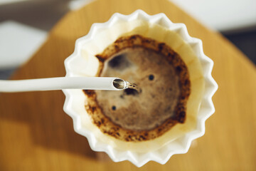 Pouring Hot Water From Kettle Into Pour Over Funnel Filled With Fresh Ground Coffee for Brewing