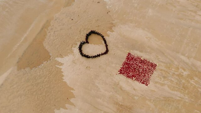 Drone Heart of roses petals on tropical sandy beach. Nobody. Love concept set up wedding ceremony. Wedding decor beach seaside