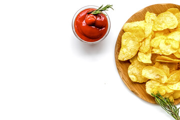 Homemade potato chips with ketchup for snack on white background top view copyspace