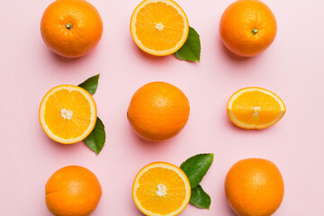 Fruit pattern of fresh orange slices on colored background. Top view. Copy Space. creative summer concept. Half of citrus in minimal flat lay