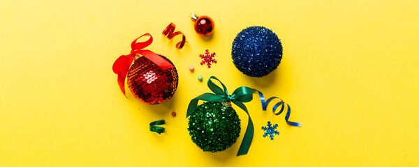 Christmas ball on colored background. decoration bauble with ribbon bow with copy space