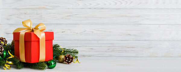 New Year Christmas mood, gift box, branches of a christmas tree, New Year decorations on a colored background