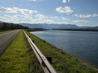 steel beam rail road divider on ashokan reservoir promenade walking biking pedestrian leisure trail path in hudson valley upstate new york (catskills mountains background) scenic leisure park travel