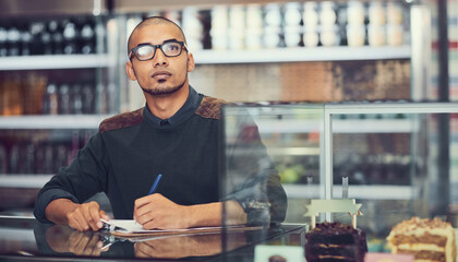 Clipboard, thinking and writing with man in coffee shop for inventory or stock inspection and planning. Checklist, glasses and idea with store owner in cafe for management of small business startup