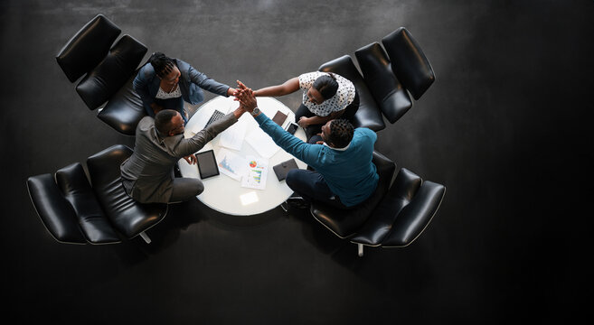 African Team Celebrating Success with Group High-Five