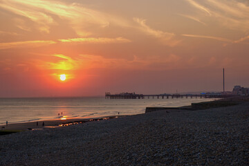 Naklejka premium sunset over Brighton Palace Pier commonly known as Brighton Pier or the Palace Pier a Grade II listed pleasure pier in Brighton England