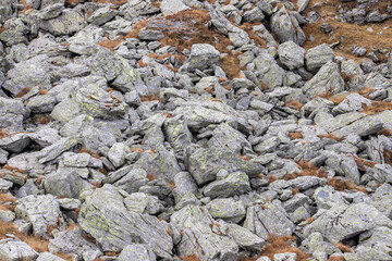 Many mountain stones on a slope