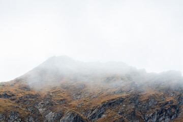 The ridge of a mountain in the fog. Mountain peak in the clouds