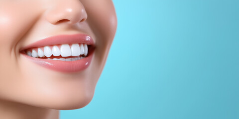 Obraz premium Close-up of a woman's healthy white teeth and radiant smile, contrasted against a softly blurred blue background, emphasizing beauty, dental care, and self-assurance.