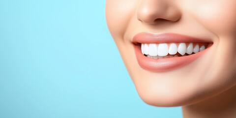Obraz premium Close-up of a woman's healthy white teeth and radiant smile, contrasted against a softly blurred blue background, emphasizing beauty, dental care, and self-assurance.