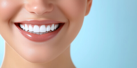 Obraz premium The joyful, bright smile of a woman showing her perfect white teeth, with a softly blurred blue gradient in the background, evoking feelings of confidence and beauty.