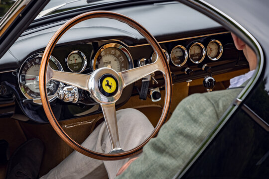 Man sitting and showing interior dash of 1962 Ferrari 250 GT Berlinetta SWB. Concours of Elegance 2024, Hampton Court Palace, London, UK