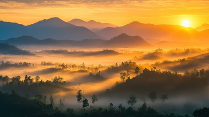 Naklejka premium Detailed shot of mist rising over the mountains of northern Thailand at sunrise.