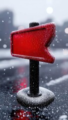 Red directional sign with frost and snow on a blurred background in winter weather.