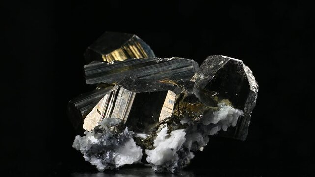 Iron Pyrite, quartz and chalcopyrite crystals  rotating slowly against a black background [Bulgaria]
