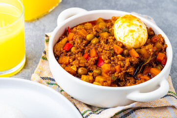 Filipino-style Picadillo with ground meat, potatoes, carrots, green peas, bell peppers and boiled egg on the side.