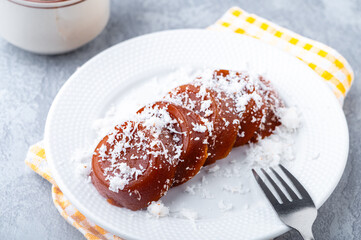 Pinoy puto kutsinta, is a type of steamed rice cake popular as street snack or merienda. It is made from a blend of rice or tapioca flour, brown sugar, and lye, giving it its distinct chewy texture.