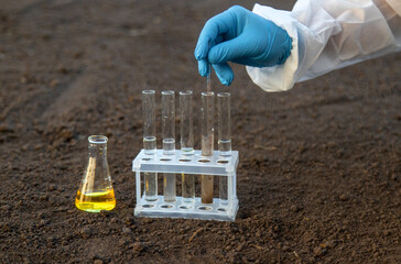Soil analysis in a test tube. Selective focus.