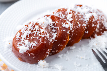 Pinoy puto kutsinta, is a type of steamed rice cake popular as street snack or merienda. It is made from a blend of rice or tapioca flour, brown sugar, and lye, giving it its distinct chewy texture.