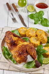 half of bbq chicken with corn cobs coins and basil