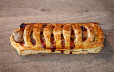 Frikandelbroodje, a dutch savoury snack consisting of a puff pastry roll with a minced meat sausage and curry sauce inside