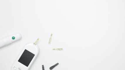 Diabetes concept with glucometer, blood test strips. Concept of worldwide diabetes awareness. Top view. Copy space