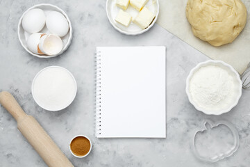 Ingredients for baking cookies for Halloween, notepad mock-up for writing down the recipe. Seasonal autumn baking