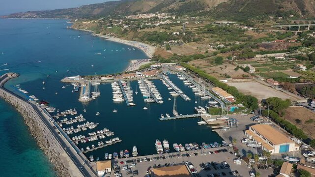 Aerial view of sea and boats in marina of Tropea town on sunny summer day in Calabria region, Italy