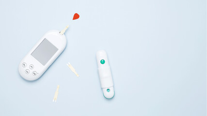 Diabetes concept with glucometer and red drop of blood. Concept of worldwide diabetes awareness