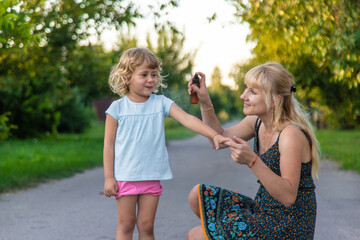 Child spraying mosquito repellent. Selective focus.