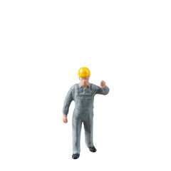 Miniature construction worker dressed in a jumpsuit isolate on white background with clipping path 