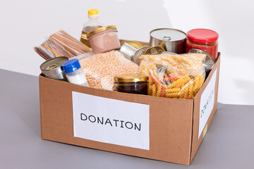 Donation Box of Free Food. Carton Box with Canned Food, Cereals and Grocery. Meal Reserves. Emergency Food Storage in Case of Crisis. Free Social Help, Blessings and Care. Strategic Food Supplies