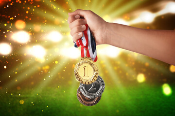 Woman with different medals at sports field, closeup