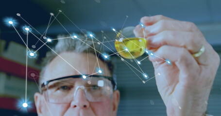 Image of network of connections over caucasian male scientist working in lab