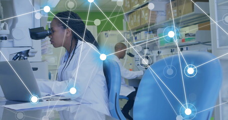 Image of network of connections over african american female scientist working in lab