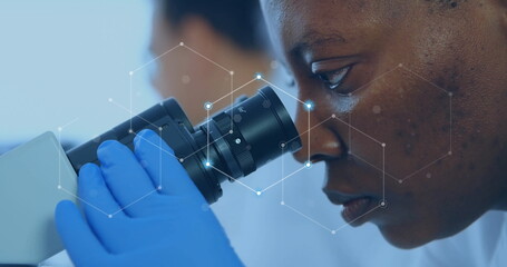 Image of network of connections over african american female scientist working in lab