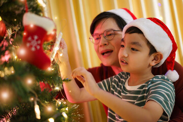 Lovely Asian family father and son are celebrating Christmas and New Year dinner party together.