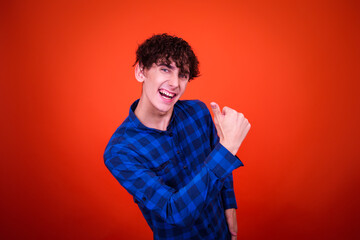 Funny young man posing in studio.