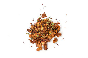 Pile of Christmas tea with cinnamon and apple on a white background. The teas are mixed together and seem to come from different regions.