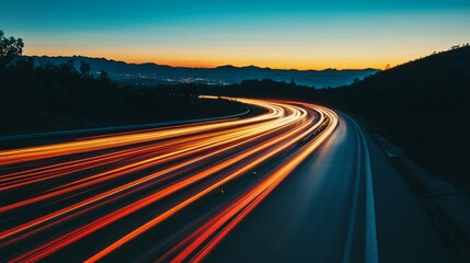 A long exposure shot of a winding road with vibrant light trails at sunset.