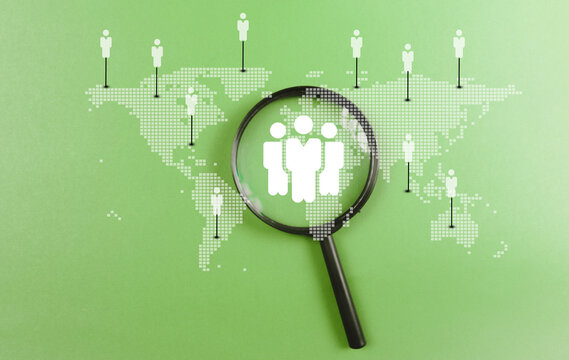 Magnifying glass focus to global customer network on world map for customer service, employment and leadership business. CRM Customer Relationship Management concept..