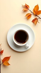 Coffee in a cup on a saucer and branches with orange leaves on a light background top view with the inscription Hello, November