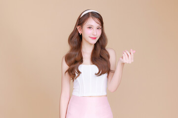 Pretty Asian beauty woman curly long hair with Korean makeup glowing face and healthy facial skin...