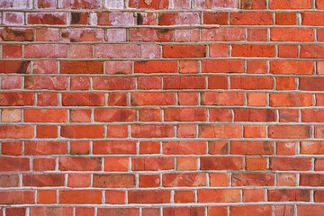Old brick red wall, brickwork from an old brick in rustic style. Structure and pattern of destroyed stone grunge wall.  Retro style background. Copy space.