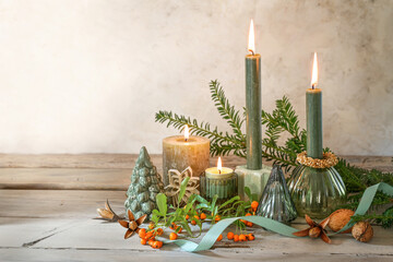 Natural Advent and Christmas decoration with four different candles, branches, berries, nuts and...